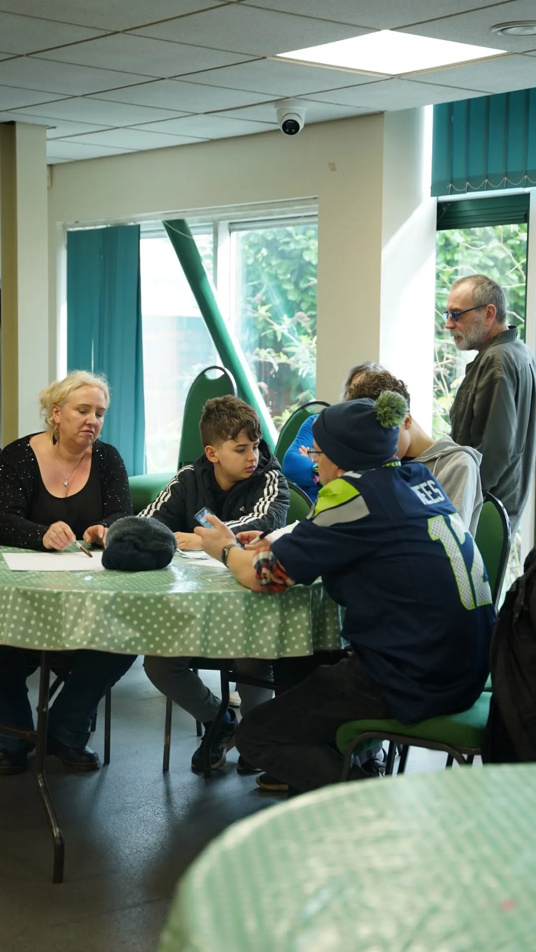 Adults and young people talking together around a table